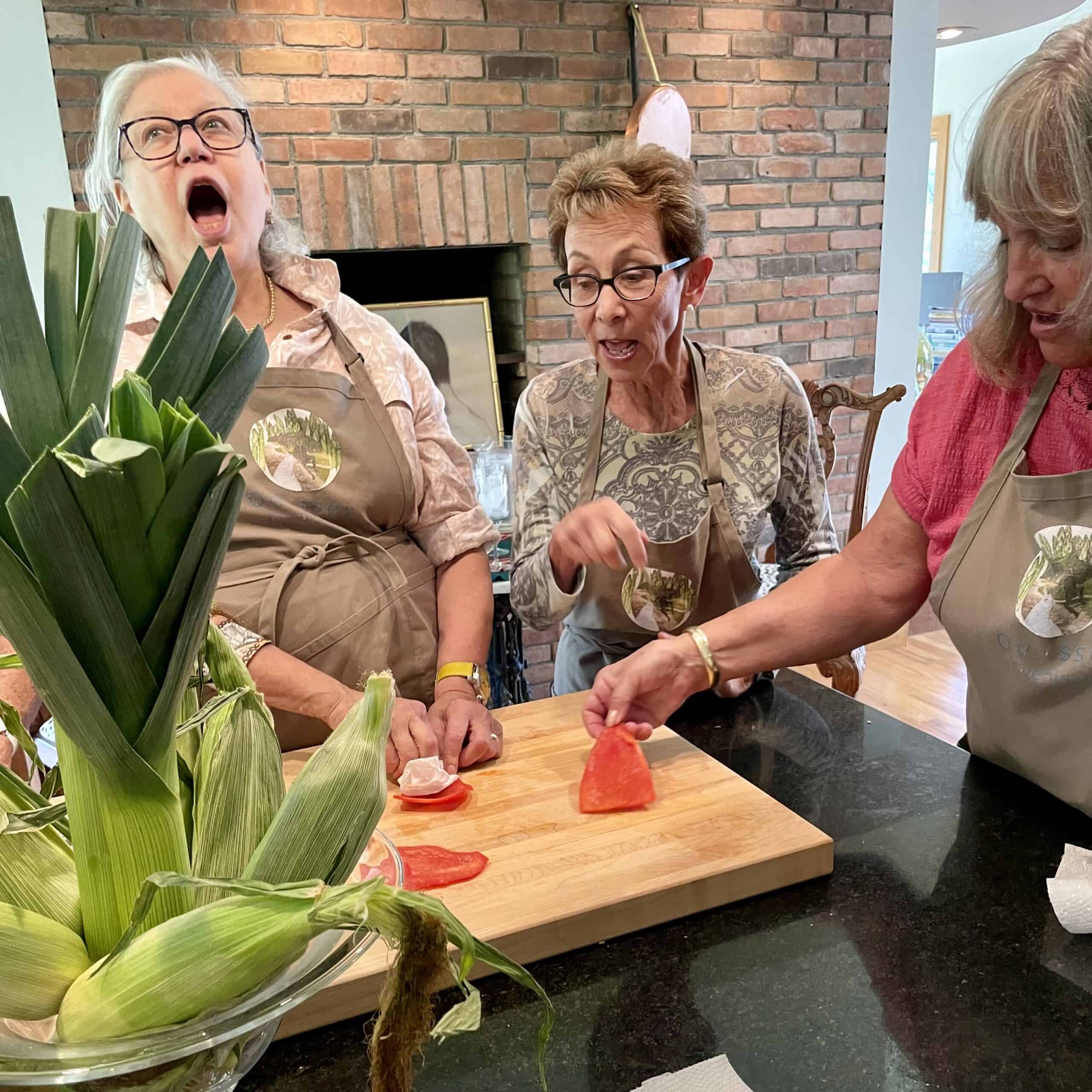 Women slicing watermelon for a cooking class at Odyssey Events.