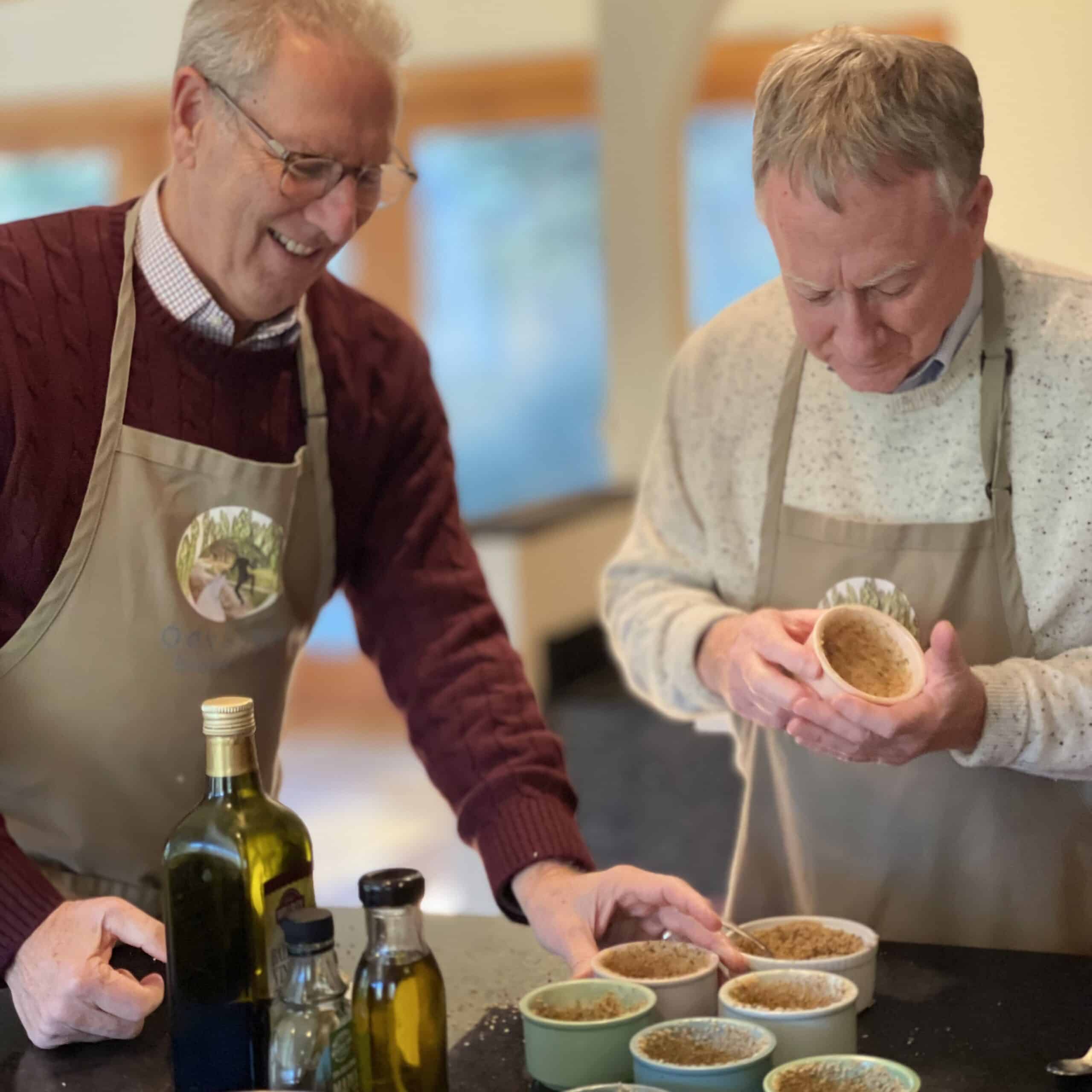Two men enjoying a fresh herb cooking class at Odyssey Events.