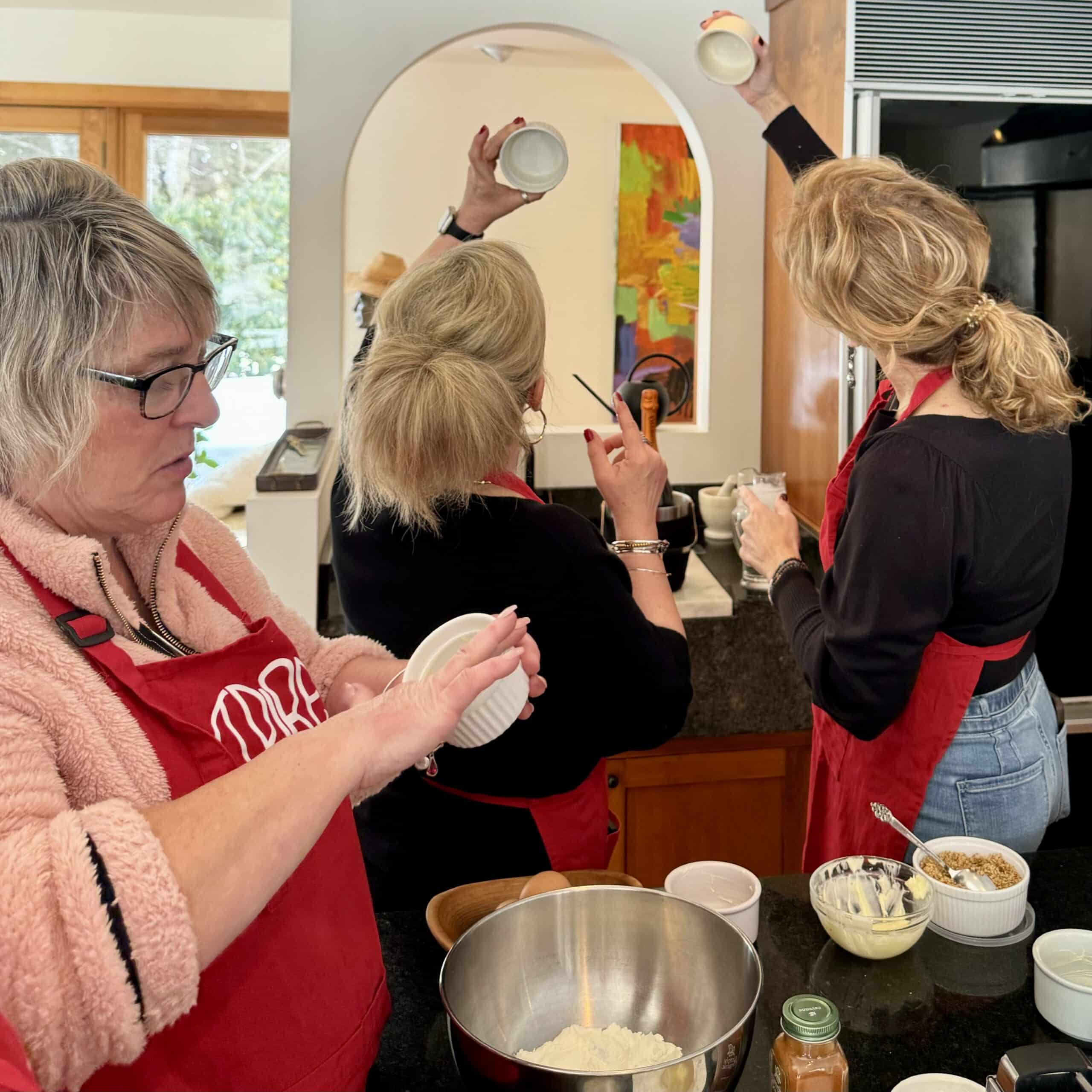 Women baking cupcakes in a cozy kitchen for a celebration.