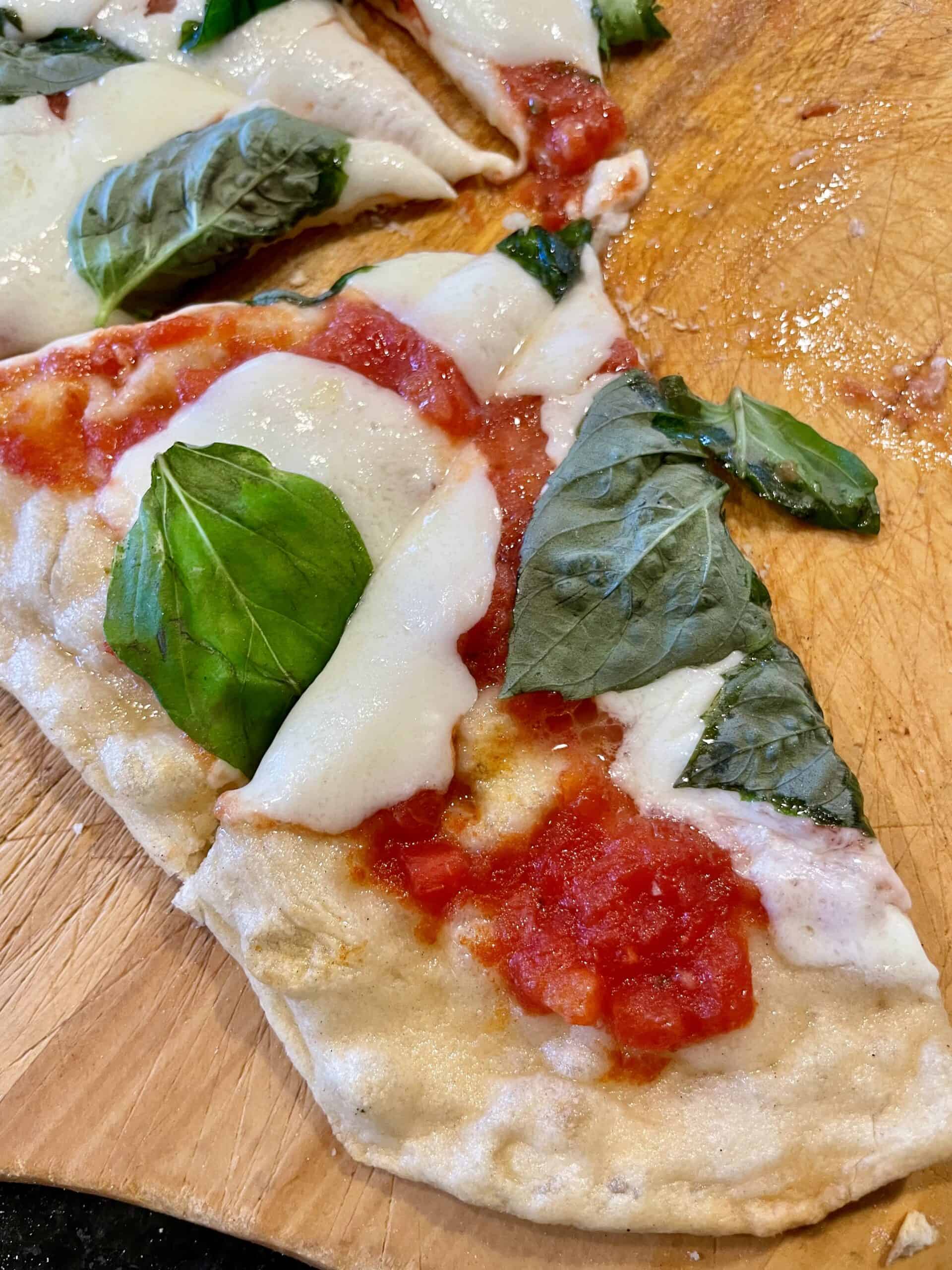 Fresh Margherita pizza with basil, mozzarella, and tomato sauce. Perfect for events and catering by.