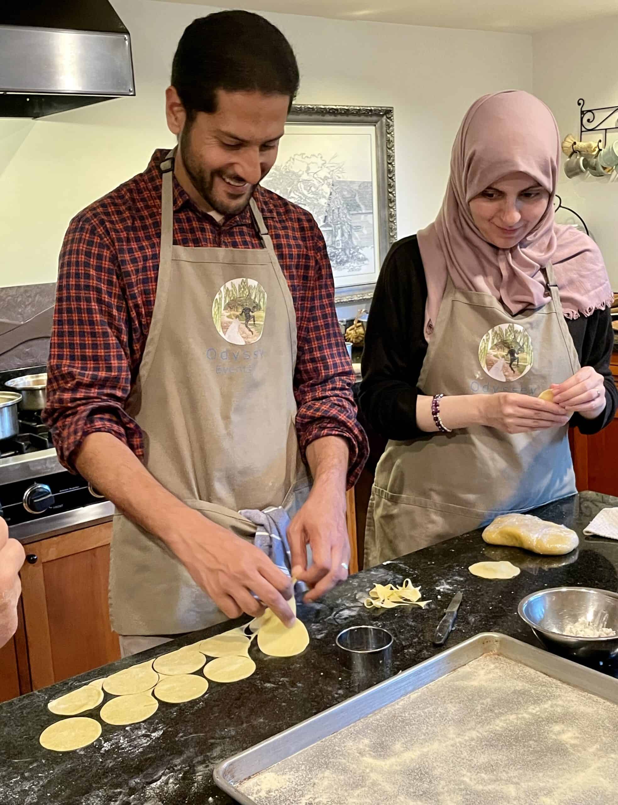 People enjoying a cooking class at Odyssey Events, preparing dough together.