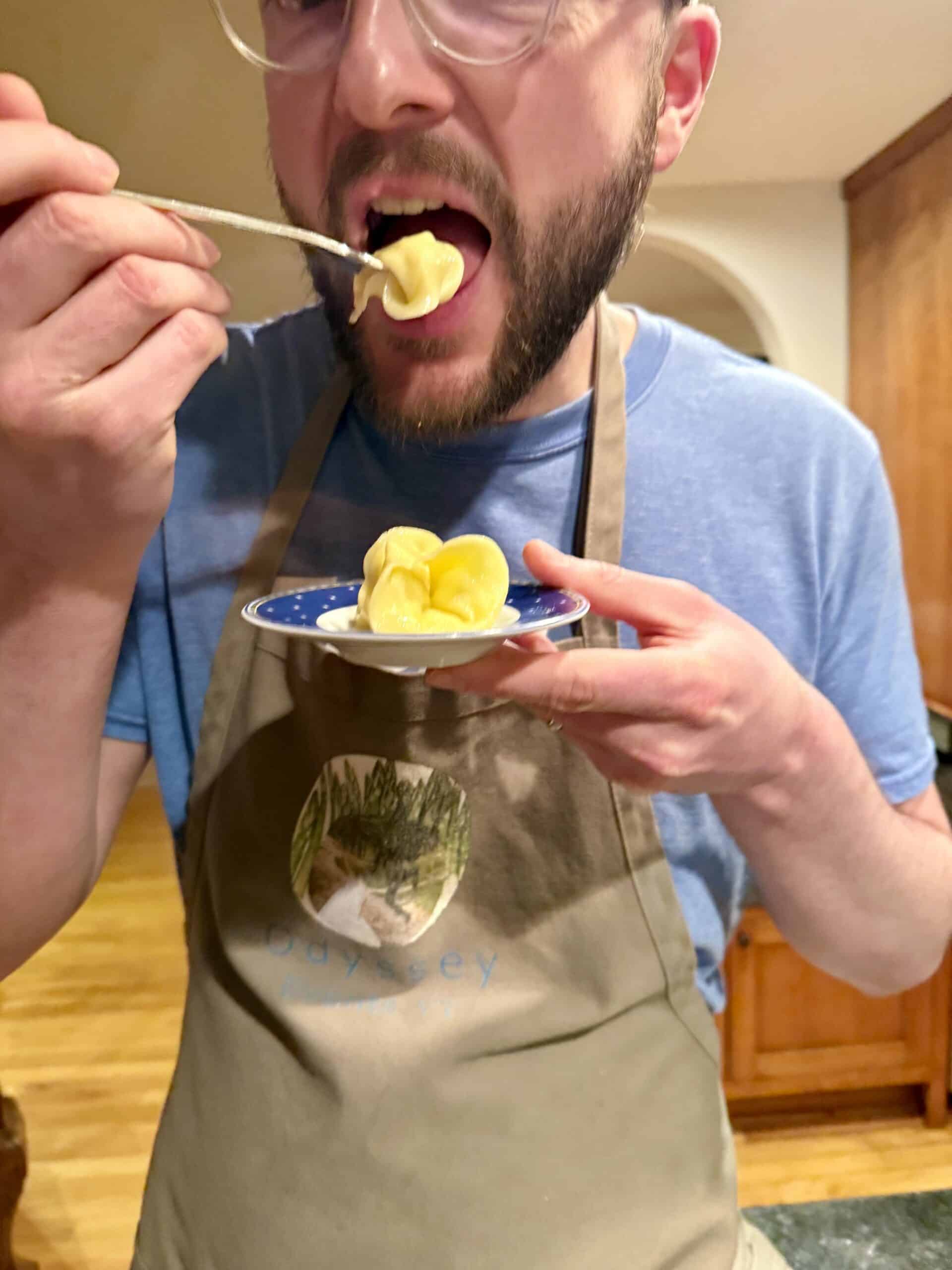 Man enjoying a food tasting experience with a spoonful of yellow dish.
