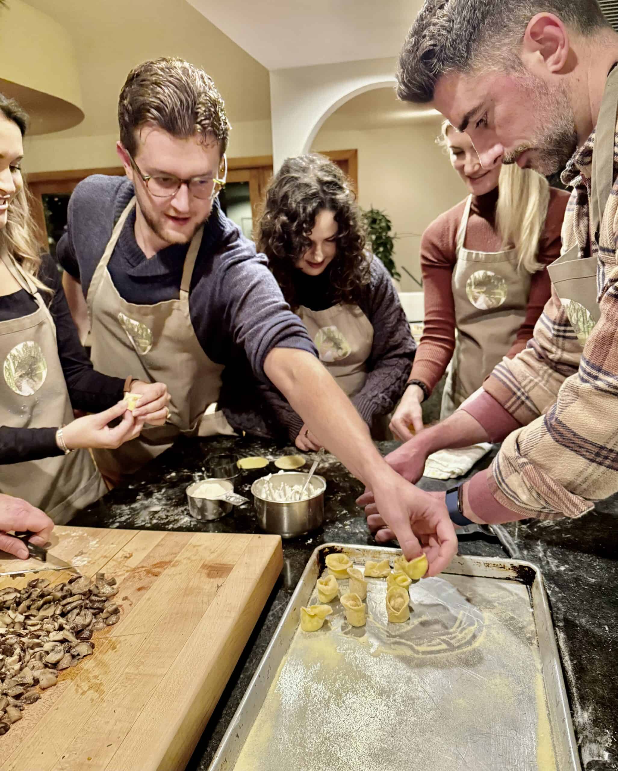 Cooking class with group preparing pasta and ravioli.