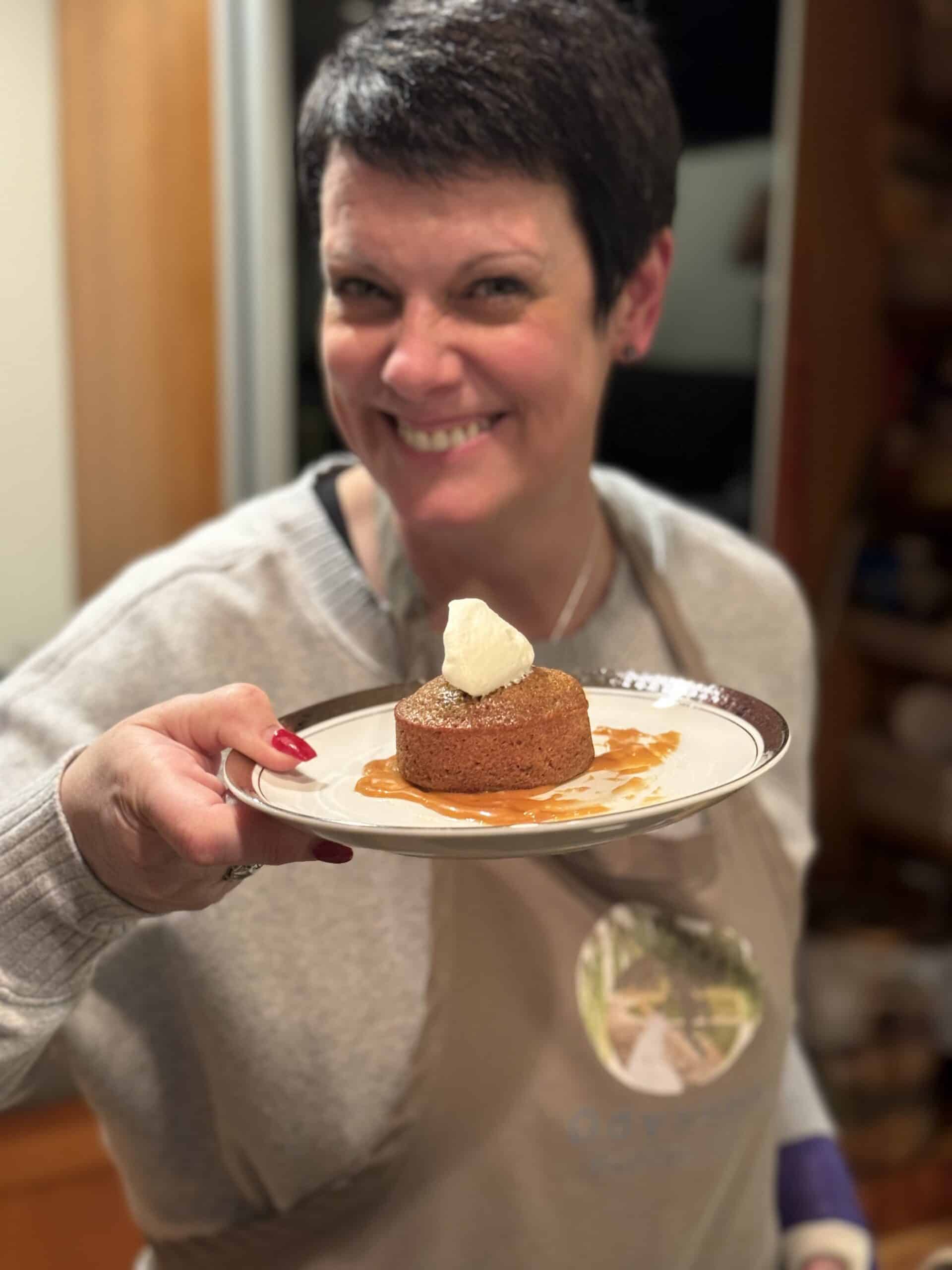 Elegant woman holding a plated dessert at Odyssey Events.