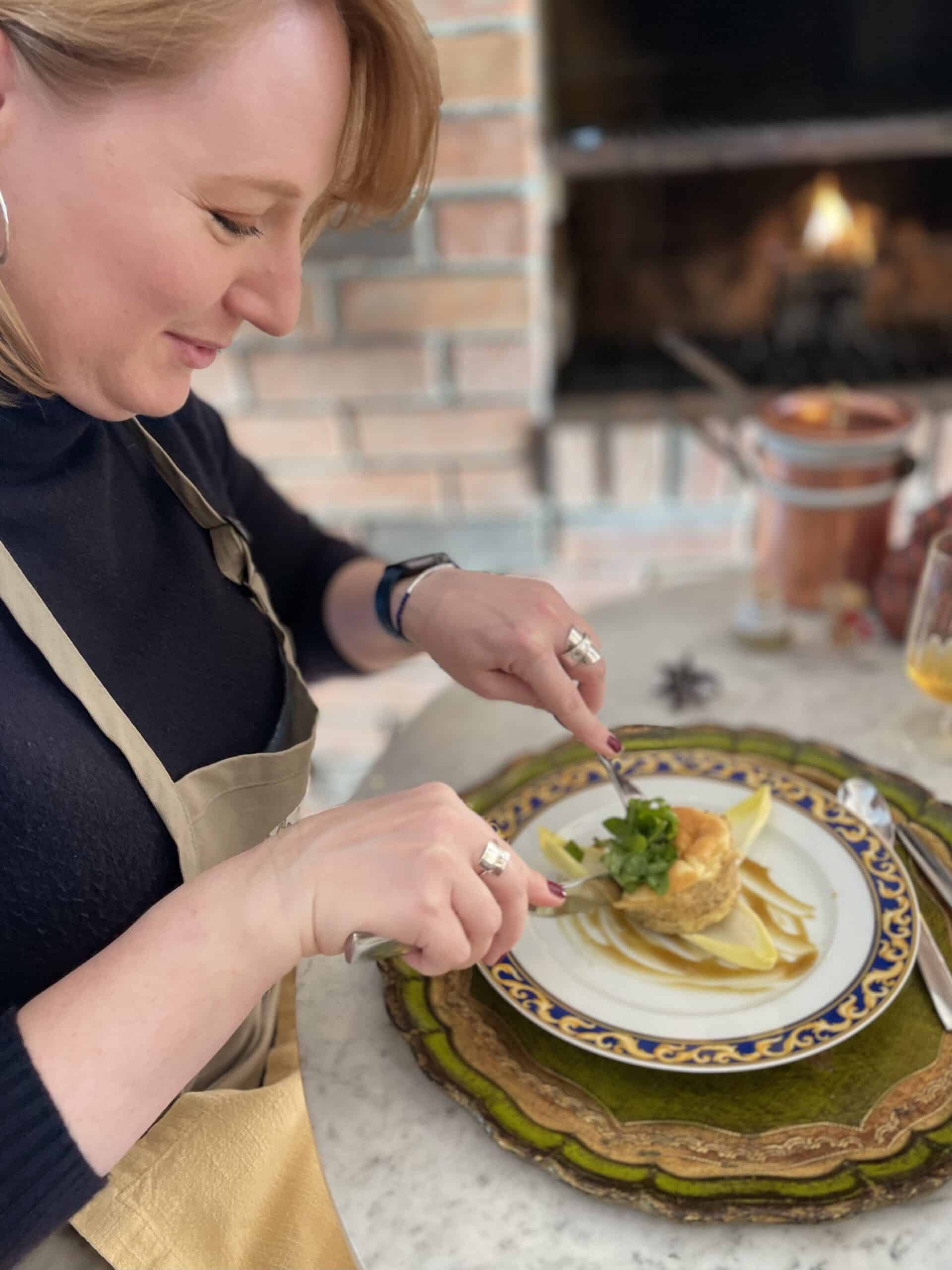 Elegant woman plating a gourmet dish at Odyssey Events.