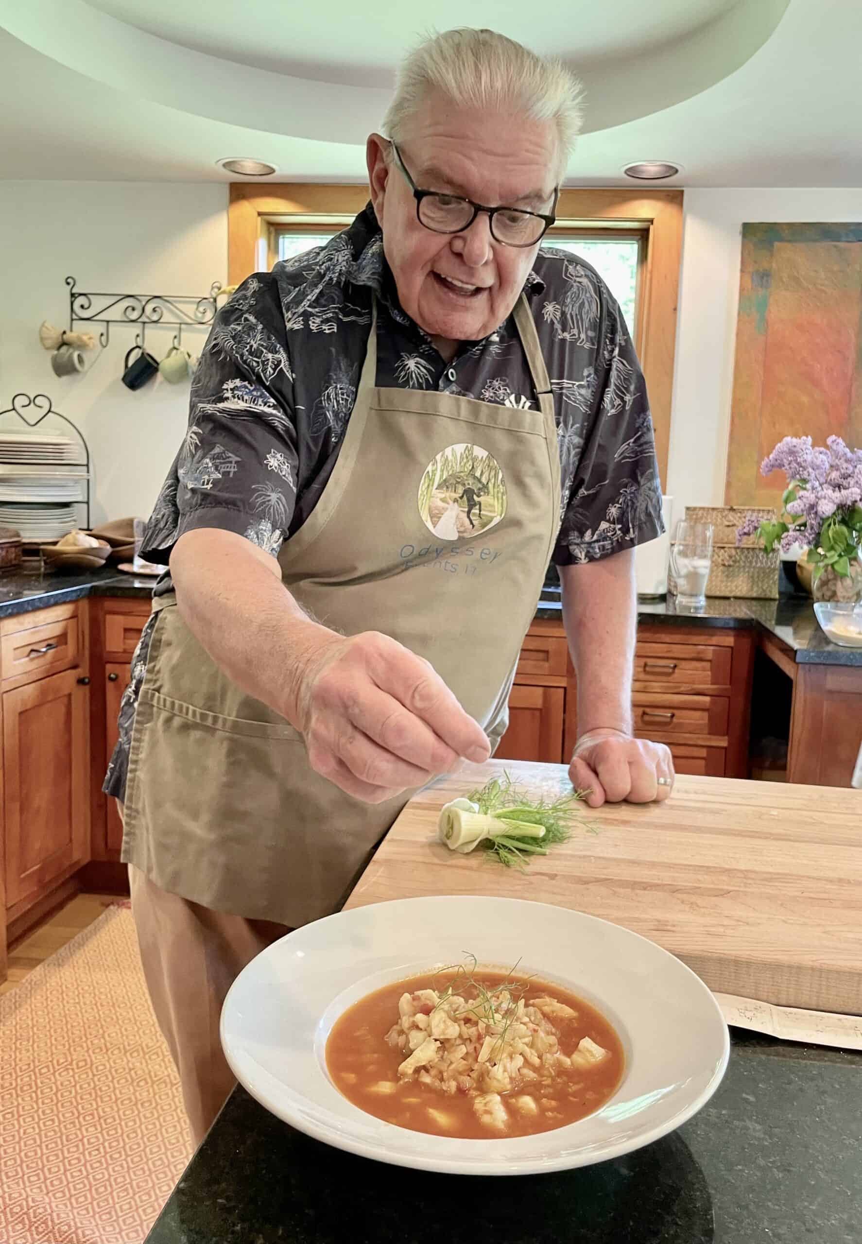 Chef preparing gourmet soup in a contemporary kitchen setting.