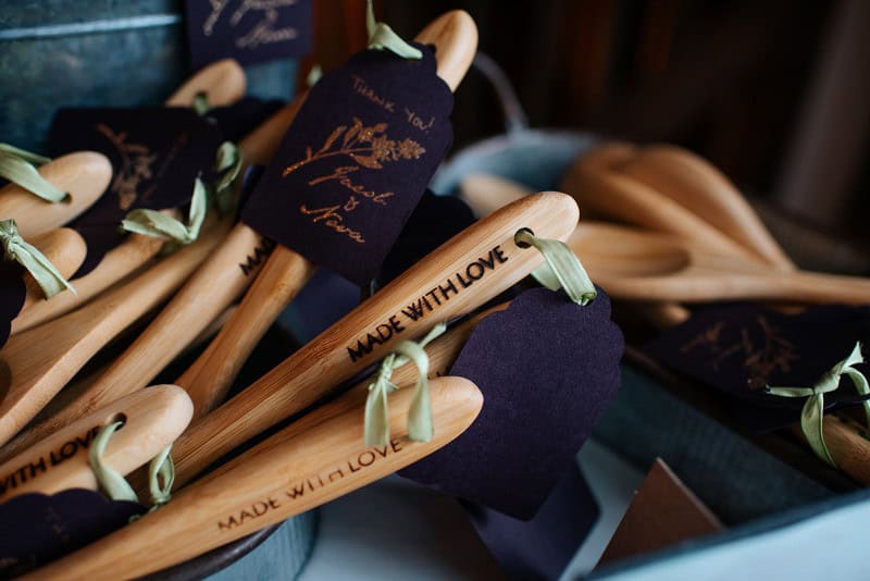 Wedding hangers with personalized "Made with Love" engraving and decorative ribbons.