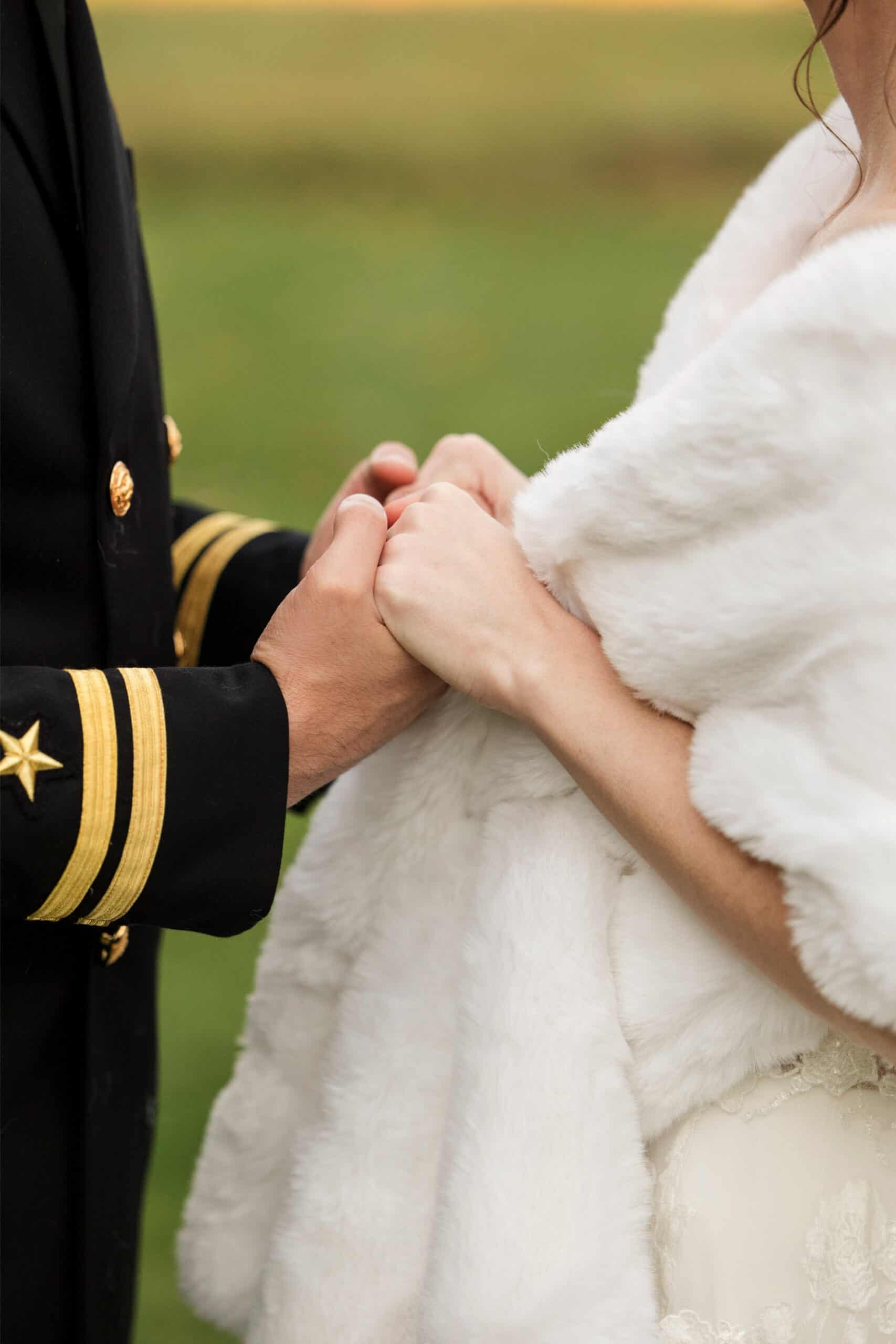 Bride and groom holding hands during wedding ceremony.
