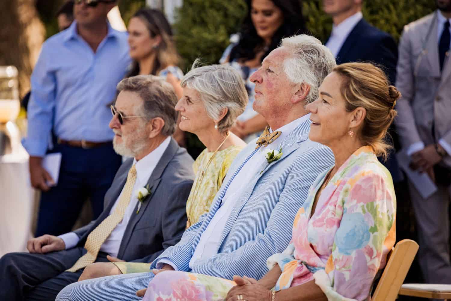 Elegant wedding guests seated outdoors at Odyssey Events.