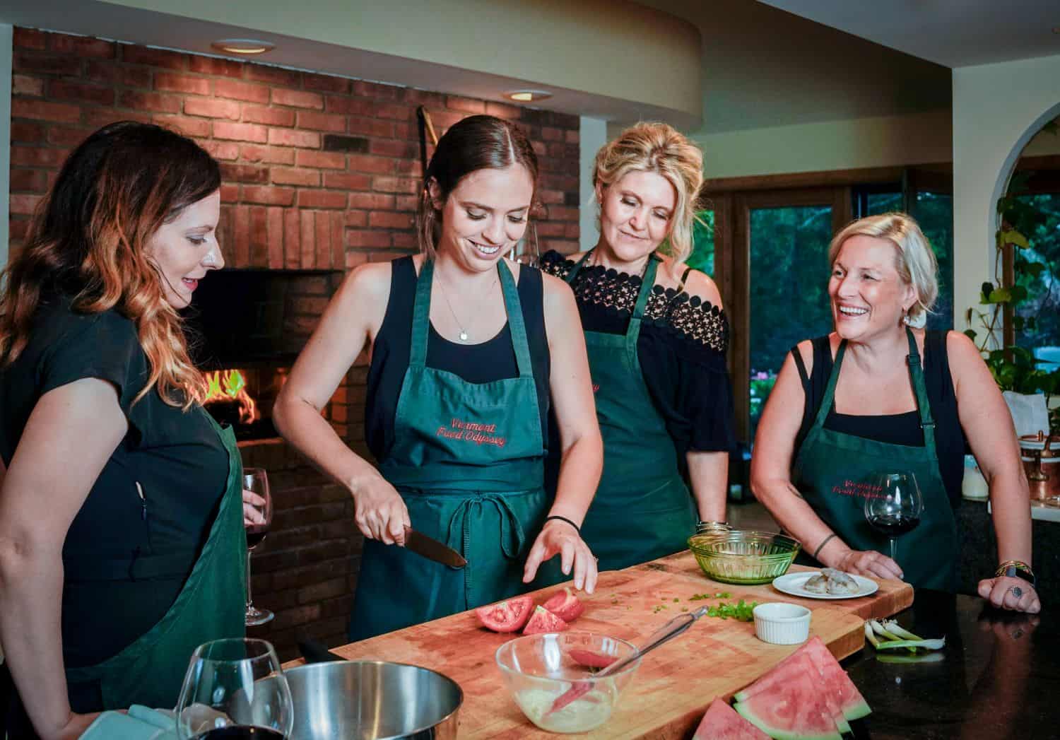 Women cooking together at a cooking class event, showcasing Odyssey Events' team-building and culina.