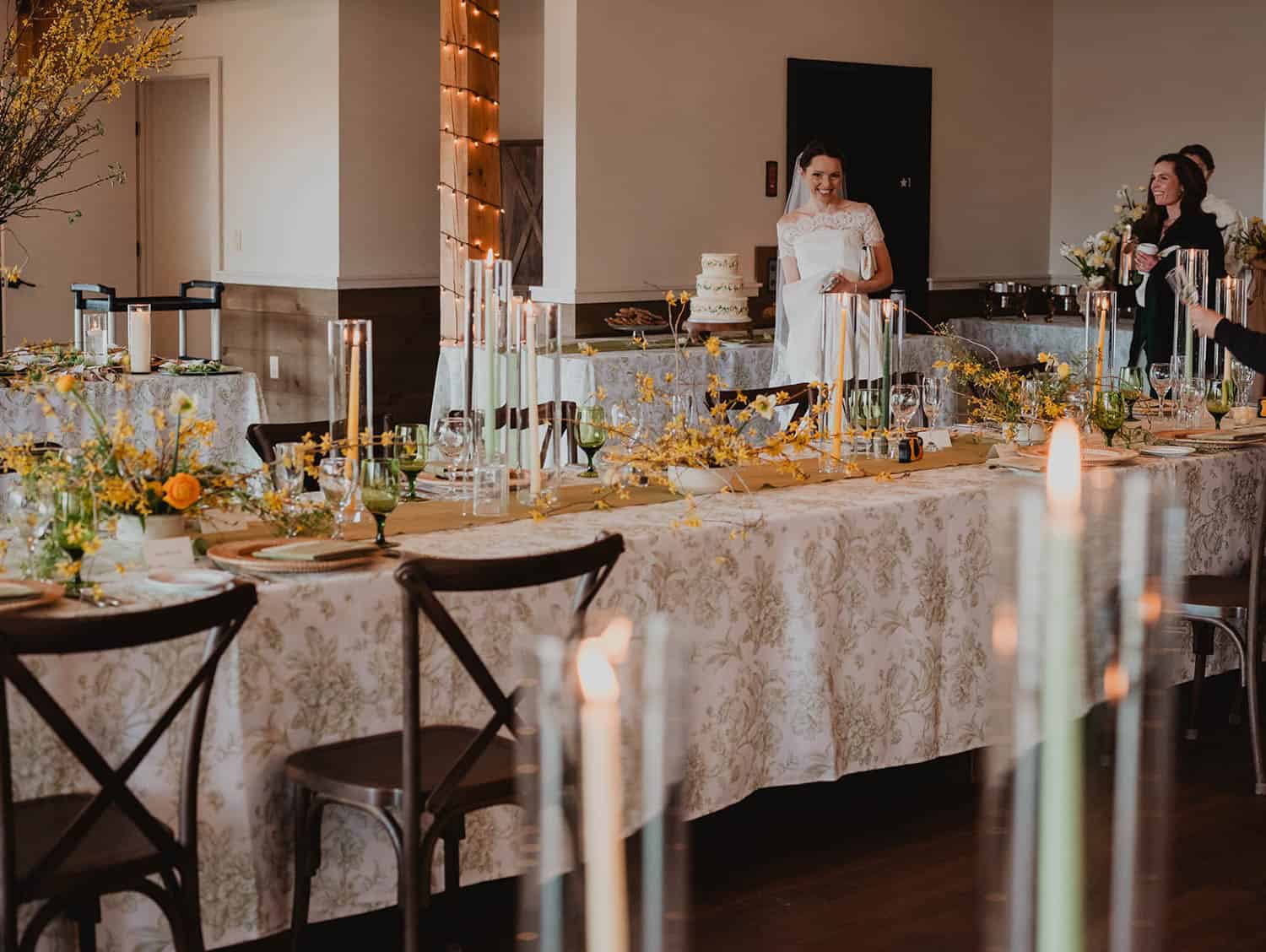 Elegant wedding reception table decorated with flowers, candles, and sophisticated tableware.